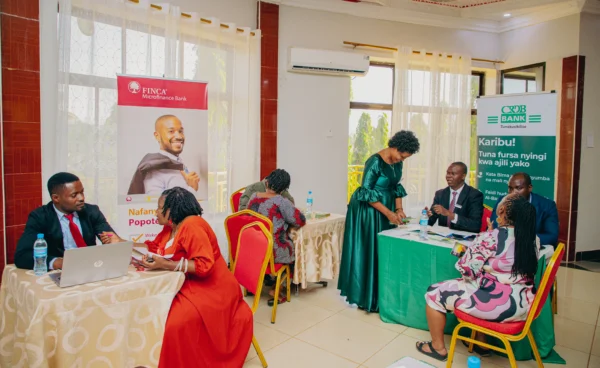 Exhibitors at a branded booth during a business forum