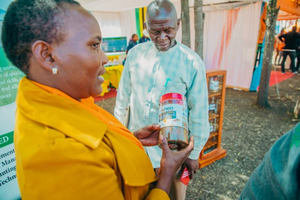 Producer holding a jar of processed product