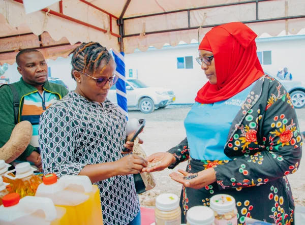 Two women examining products at an exhibition stand