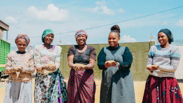 Group of women standing together at a community agricultural project